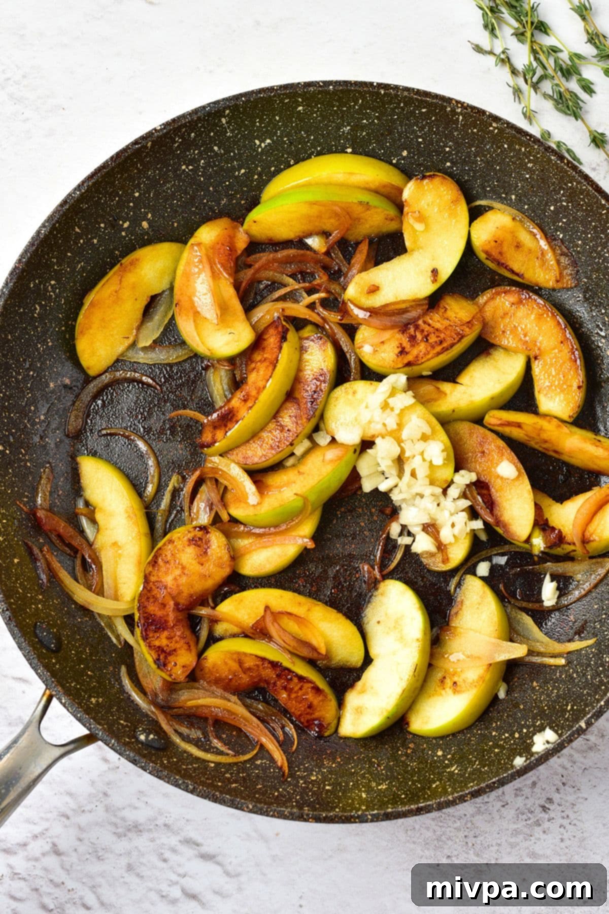 Pork Chops and Apples in Skillet Sautéing sliced apples, onions, and garlic in the same skillet
