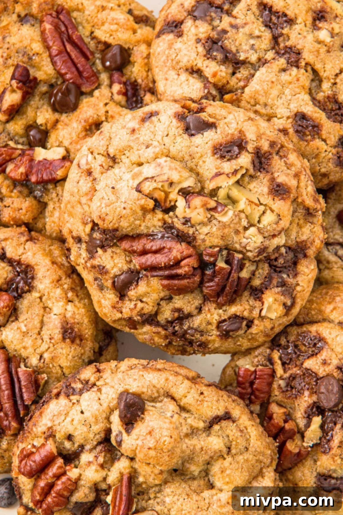 Brown Butter Pecan Chocolate Chip Cookies (Gluten-Free) Top down view of brown butter pecan chocolate chip cookies, perfectly baked and garnished.