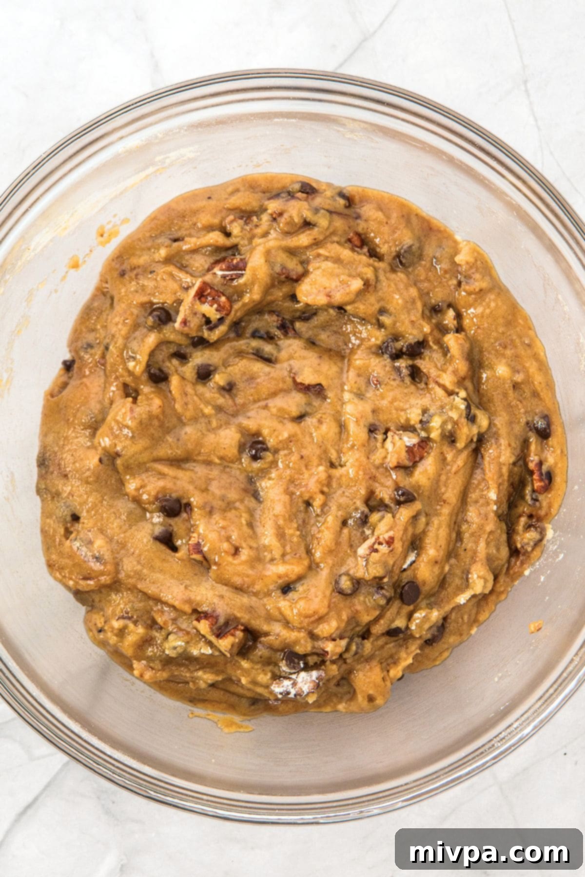 Brown Butter Pecan and Chocolate Chip Cookies (Gluten-Free) Bowl of cookie dough with visible chocolate chips and pecans, ready for chilling.