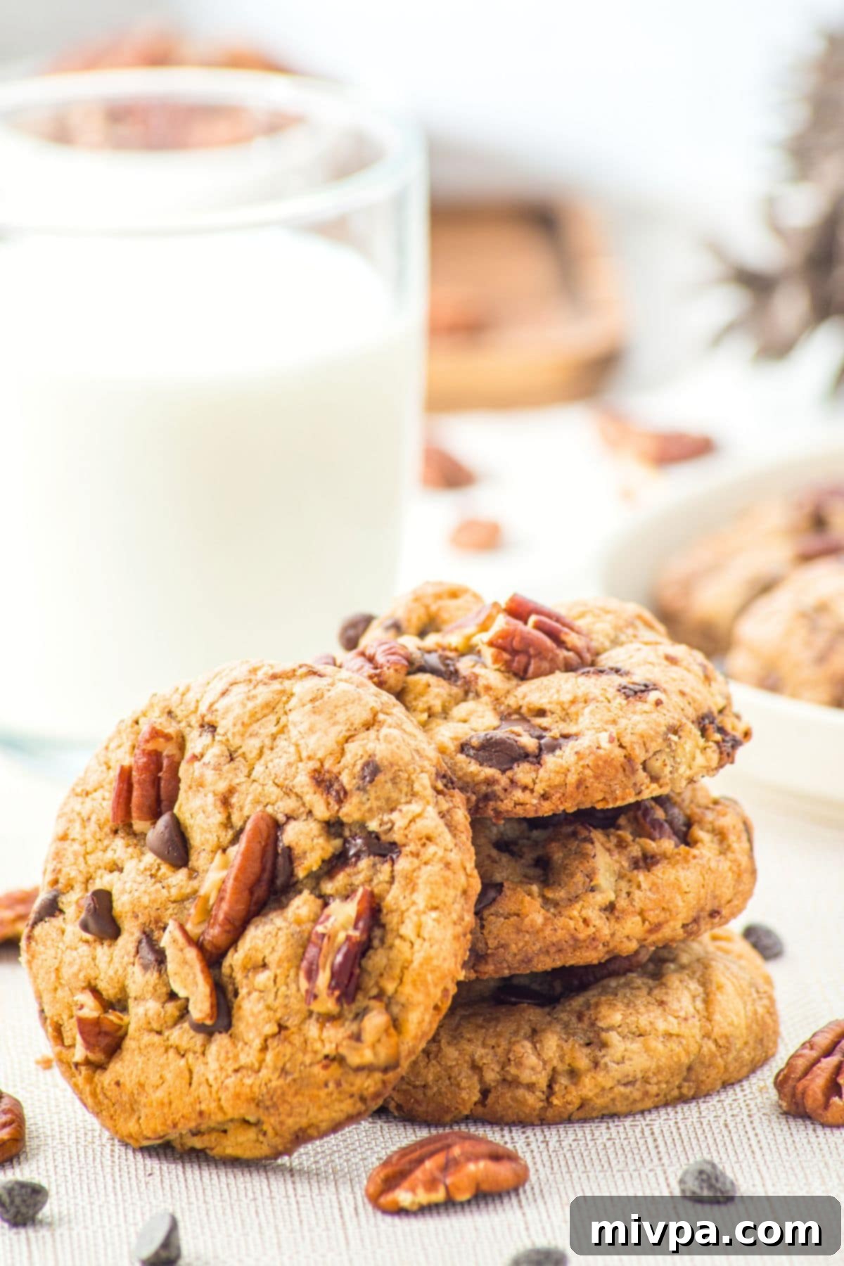 Browned Butter Pecan Chocolate Chip Cookies (Gluten-Free) Close-up of browned butter pecan chocolate chip cookies with a glass of milk.