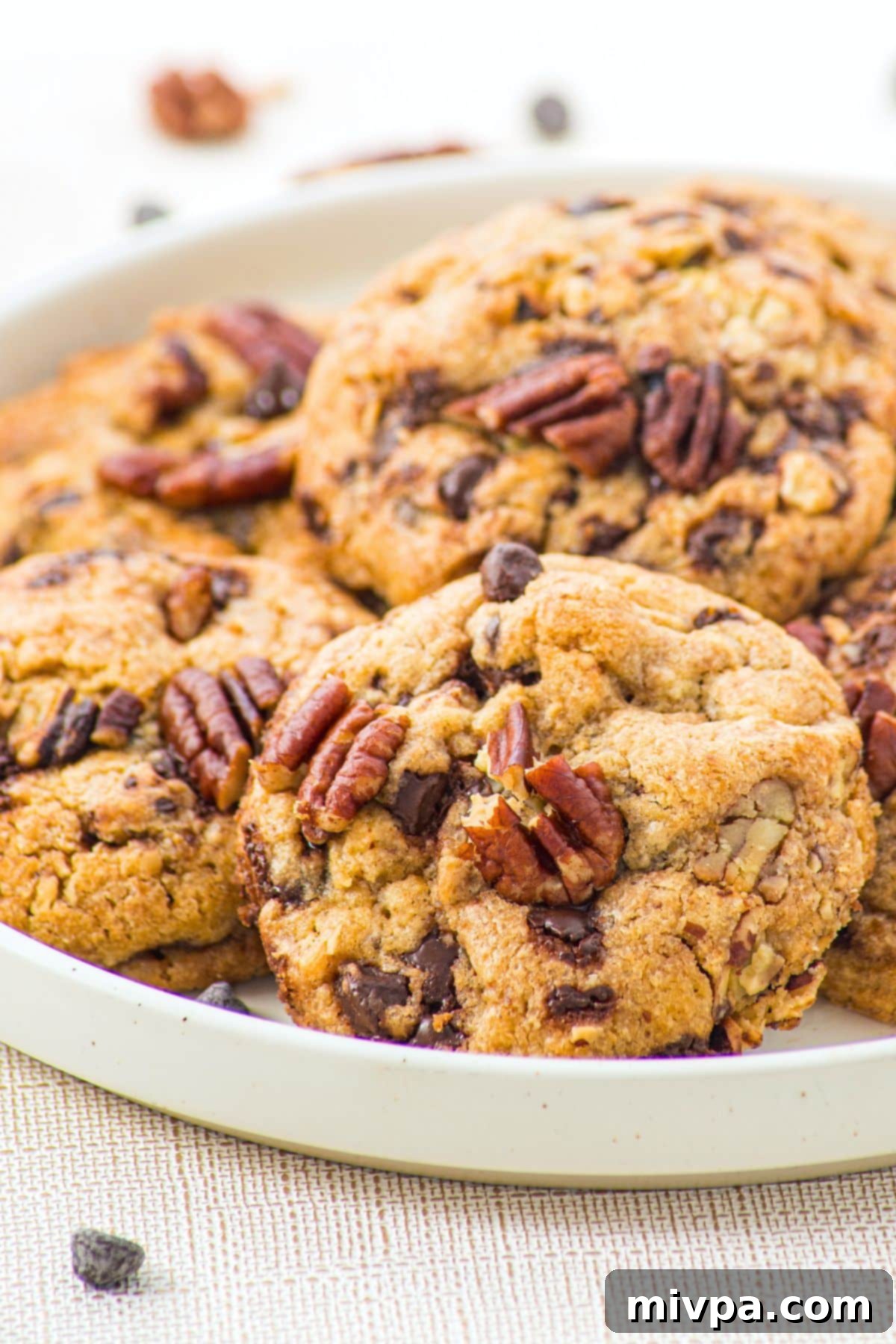 Brown Butter Pecan and Chocolate Chip Cookies (Gluten-Free) A plate of perfectly baked pecan and chocolate chip cookies, ready to be served.