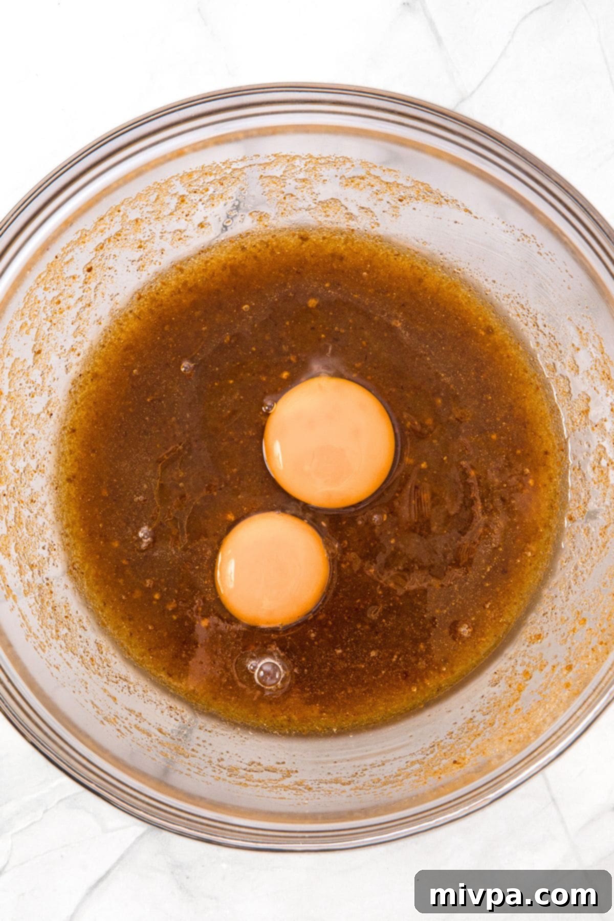 How to Make Pecan Chocolate Chip Cookies Egg, egg yolk, and vanilla extract added to the brown butter and sugar mixture.