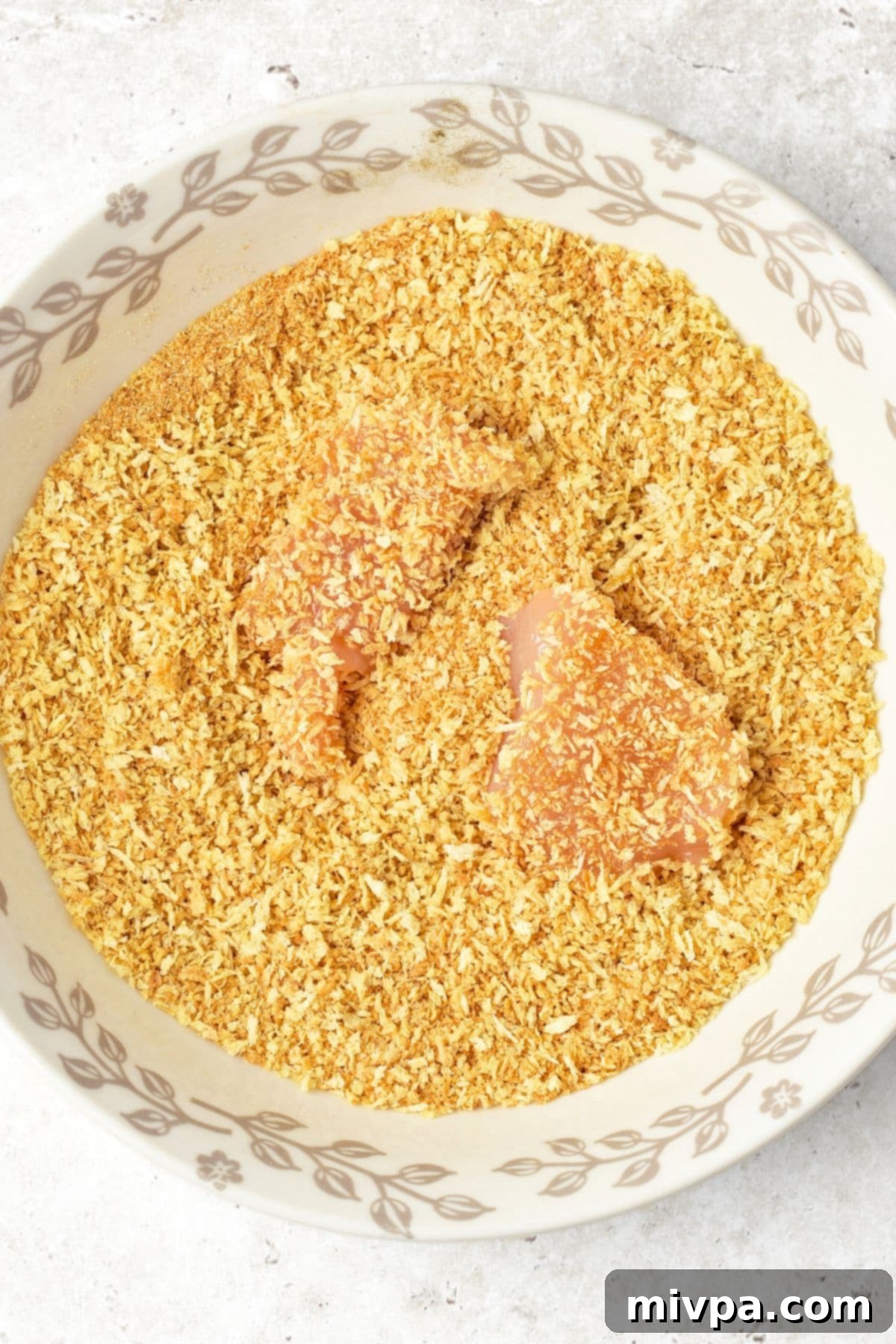 Homemade Turkey Nugget Recipe Coating turkey pieces evenly in breadcrumbs.