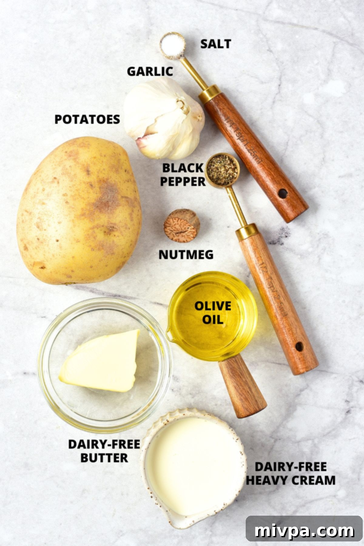 Creamy Roasted Garlic Mashed Potatoes Recipe (Gluten-Free, Vegan) Ingredients for roasted garlic mashed potatoes recipe laid out on marble board.