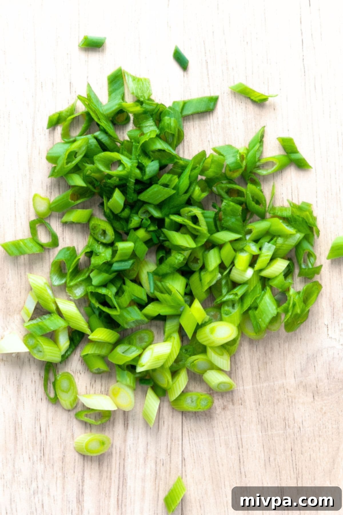 Fully Loaded Tater Tots Recipe Sliced green onions on wooden board